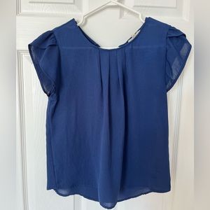 Navy blouse with bow details in the back.